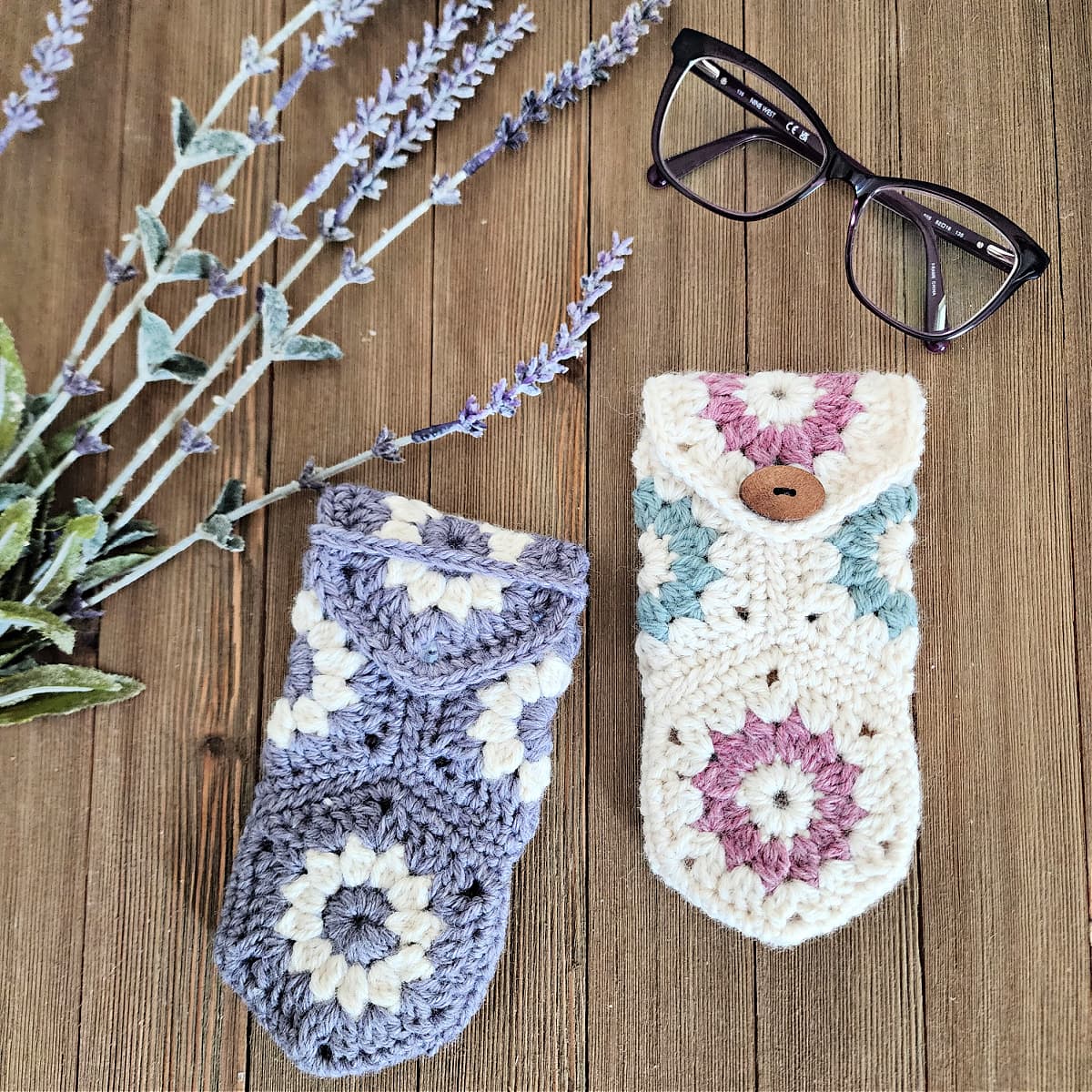 Spring colored crochet eyeglass cases laying with purple glasses and lavender.