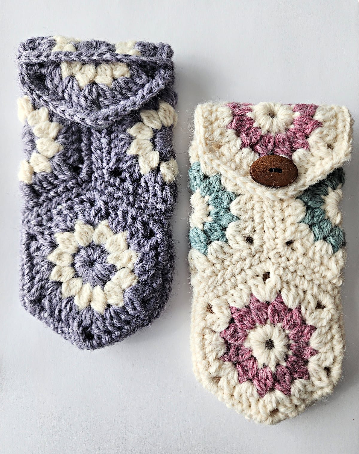 Two crochet eyeglass cases. One with button closure and the other with a strap closer.