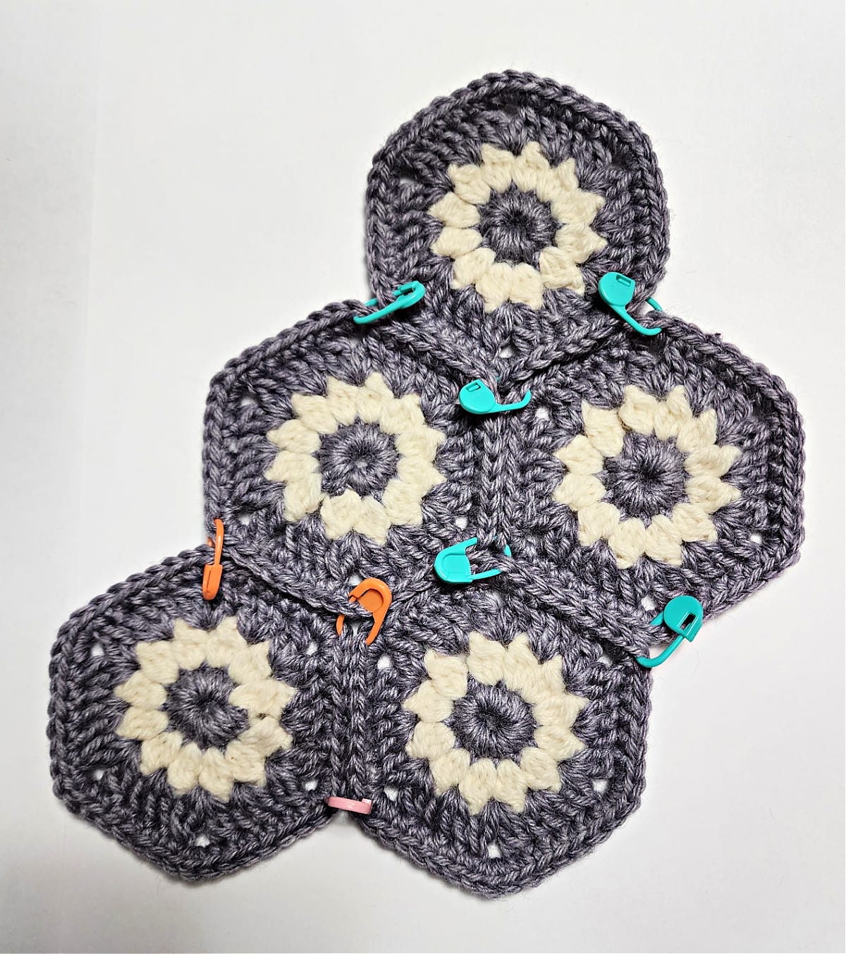 Crochet hexagons held together with stitch markers before seaming.