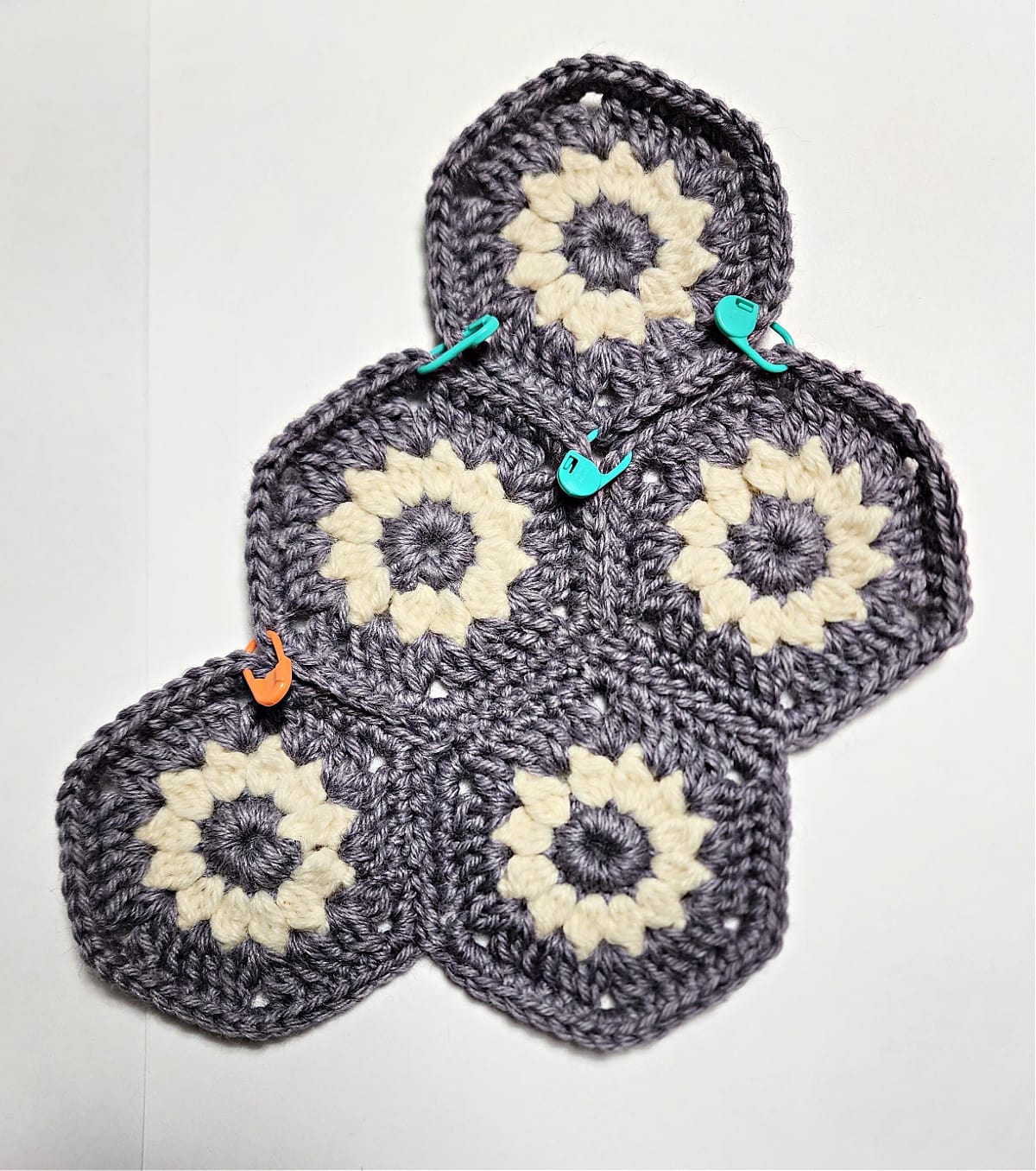 Joining crochet hexagons with whipstitches.