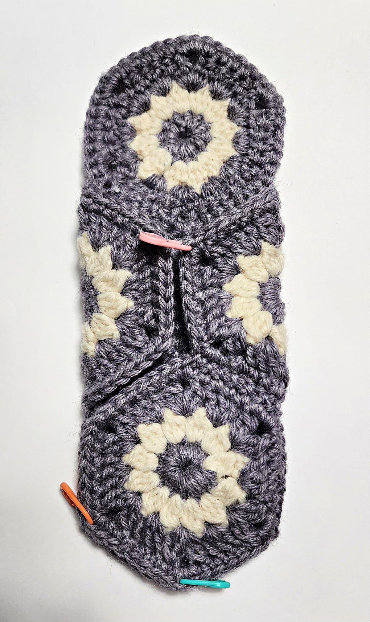 Crochet motifs folded to create a hexagon pouch.