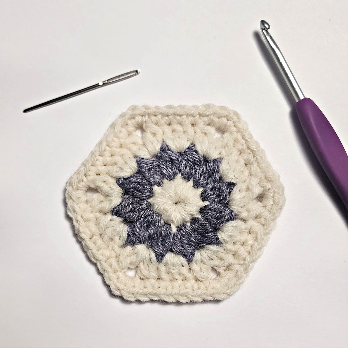 One 3 inch crochet hexagon motif in cream and purple.