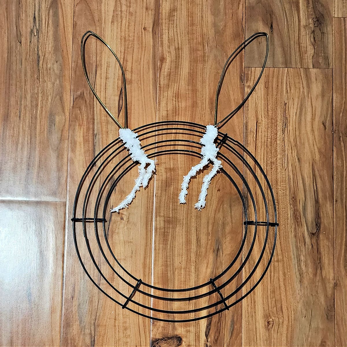 Both bunny ears secured to wire wreath.