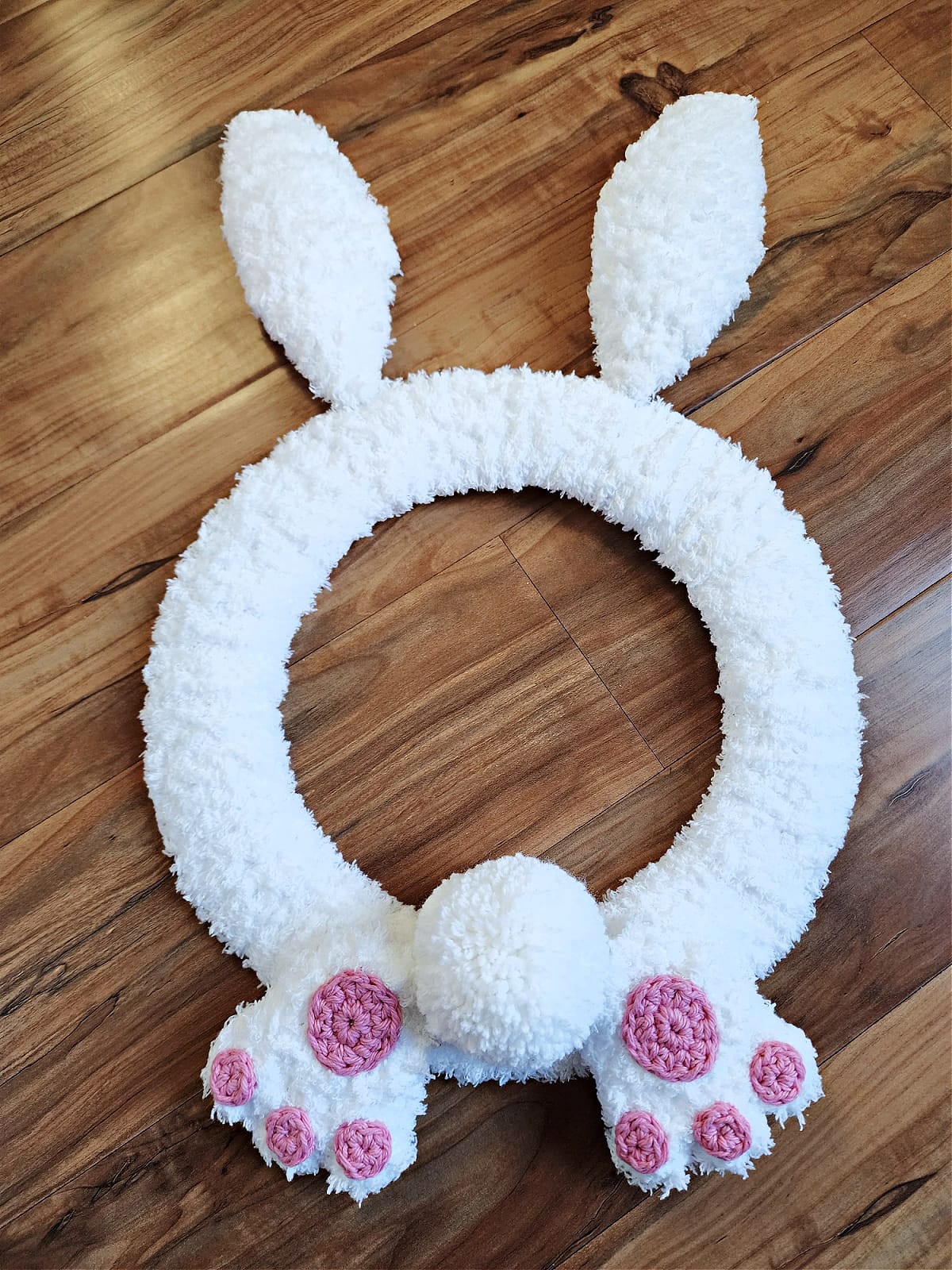 Crochet bunny wreath with bunny butt and bunny feet.