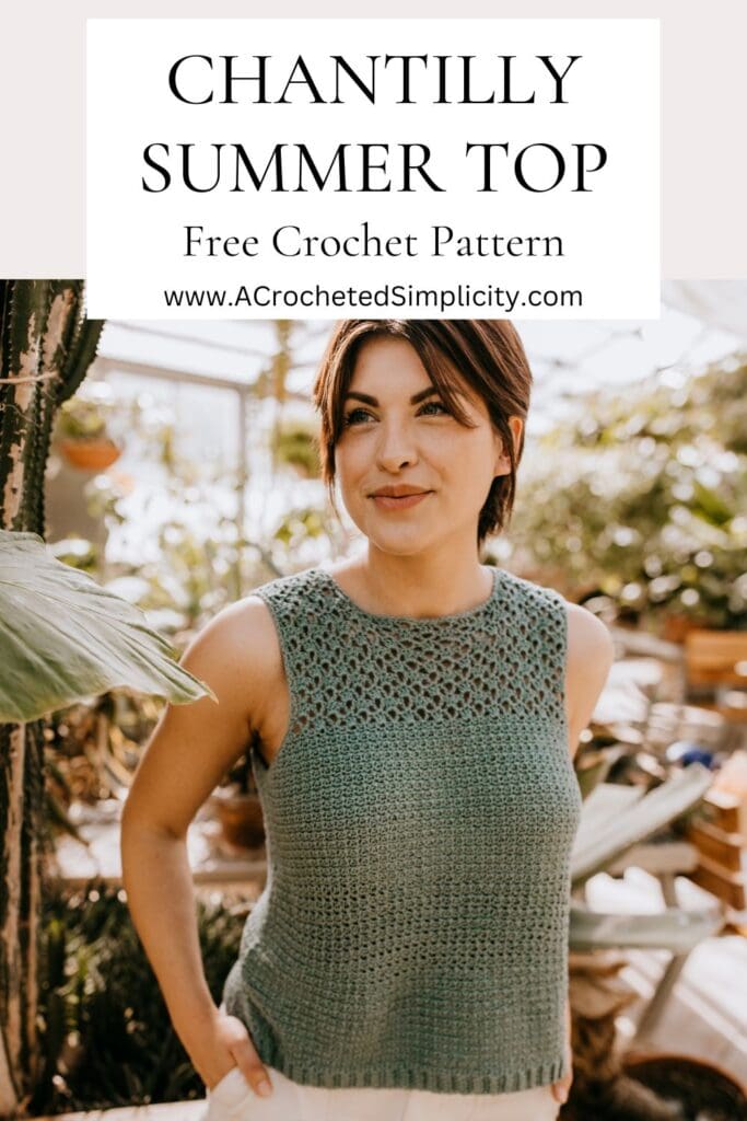 A woman with a hand in her pocket wearing a light green summer crochet top.