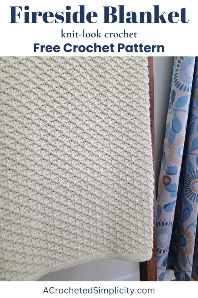 Close-up of a crochet blanket pattern hanging on a blanket ladder near a floral curtain.