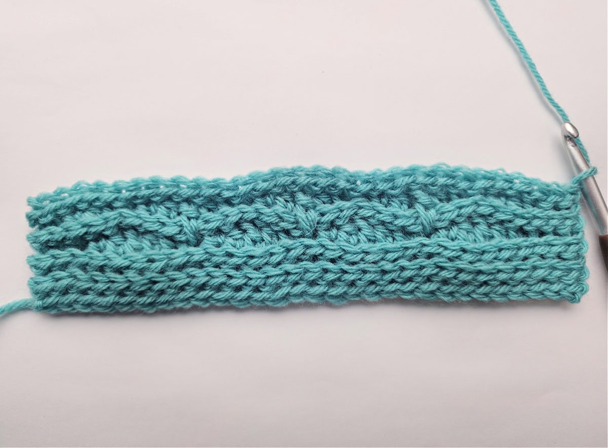The right side of a knit look crochet blanket swatch.