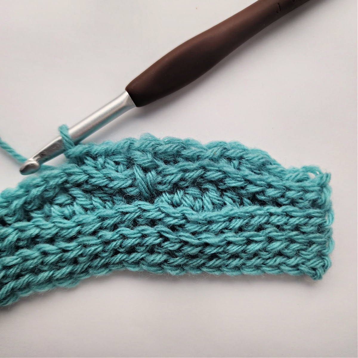 The beginning of a knit-look stitch pattern repeat.