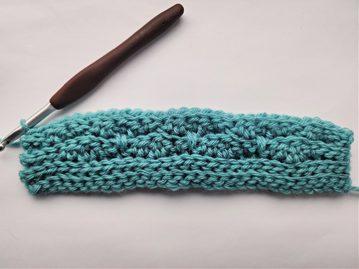 The backside of a knit-look crochet swatch for a blanket.