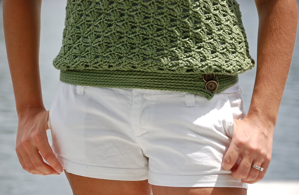 White shorts and a green crochet tank top.