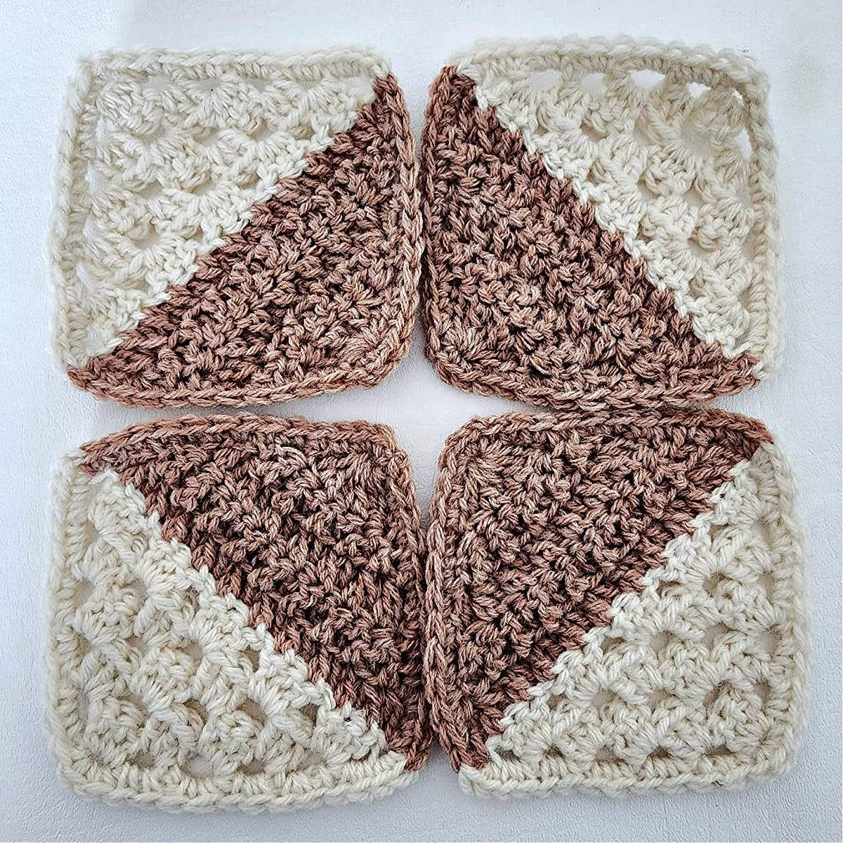 Four granny square motifs laid out for seaming.
