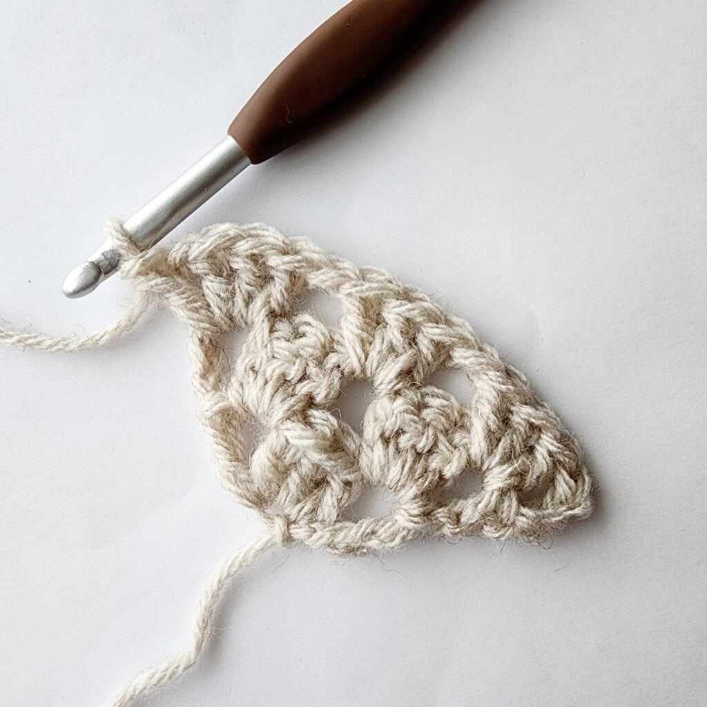 Third row of increase of a crochet granny square motif.