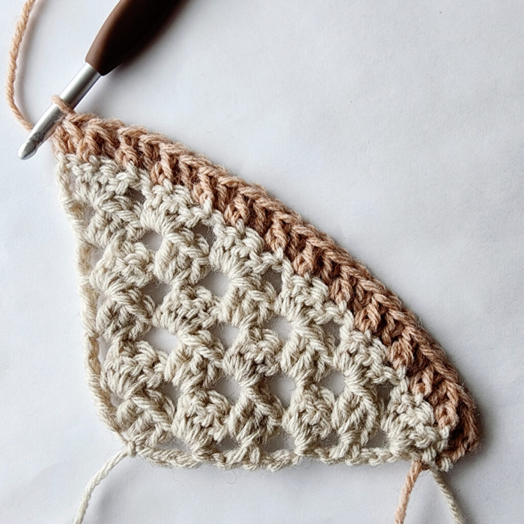 First row of decrease of a crochet granny square motif.