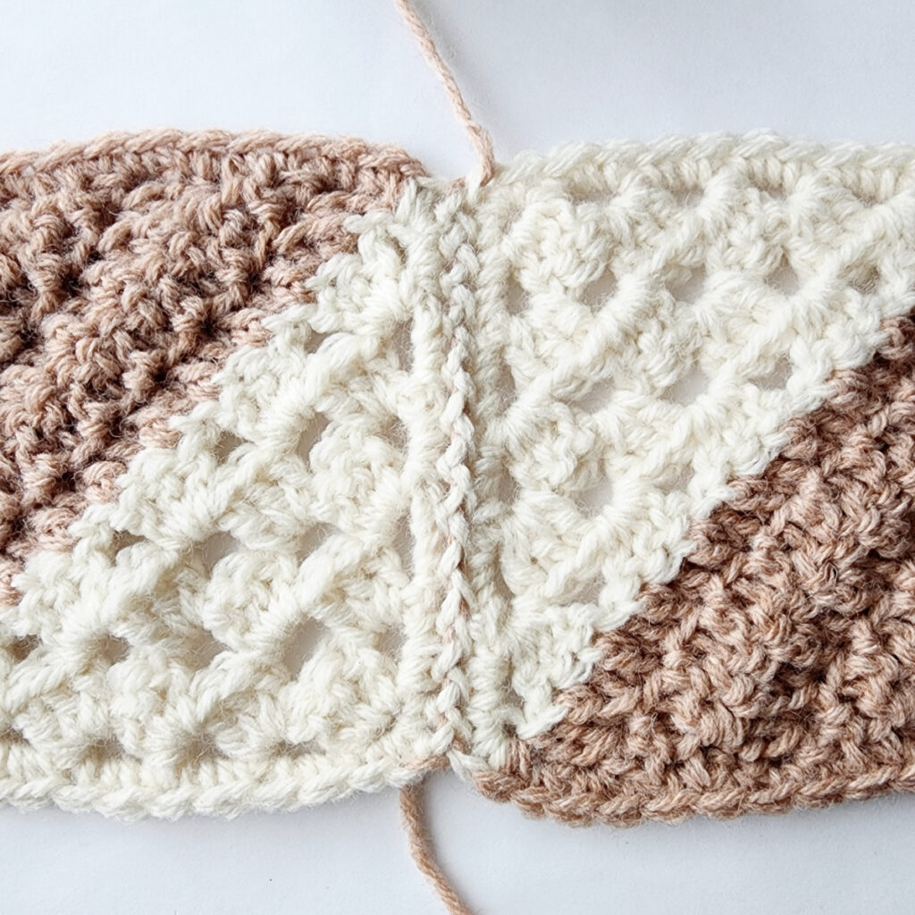 Two crochet granny square motifs seamed together.