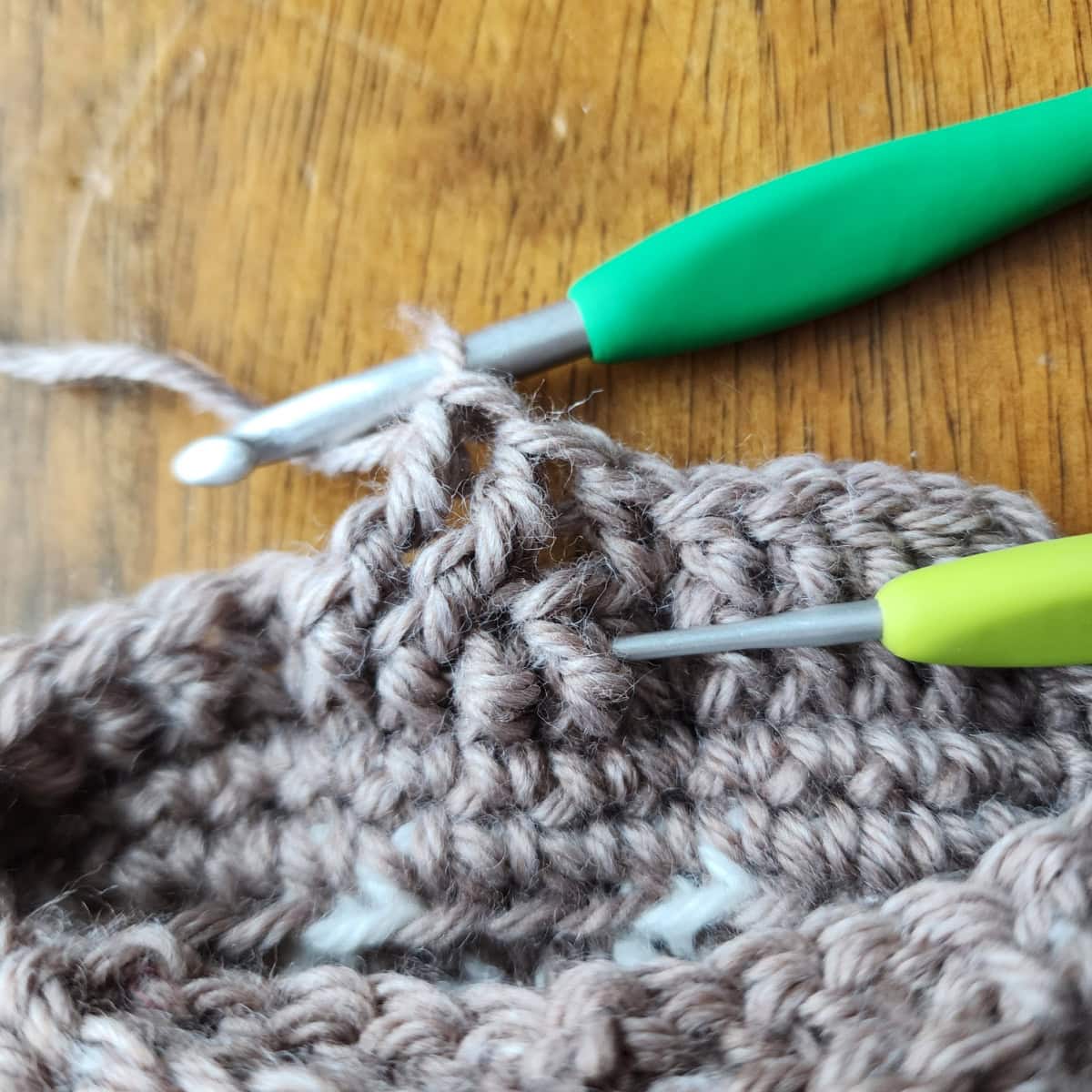 Working the 4-strand cable twists of the decorative cuff of the crochet slipper boot.