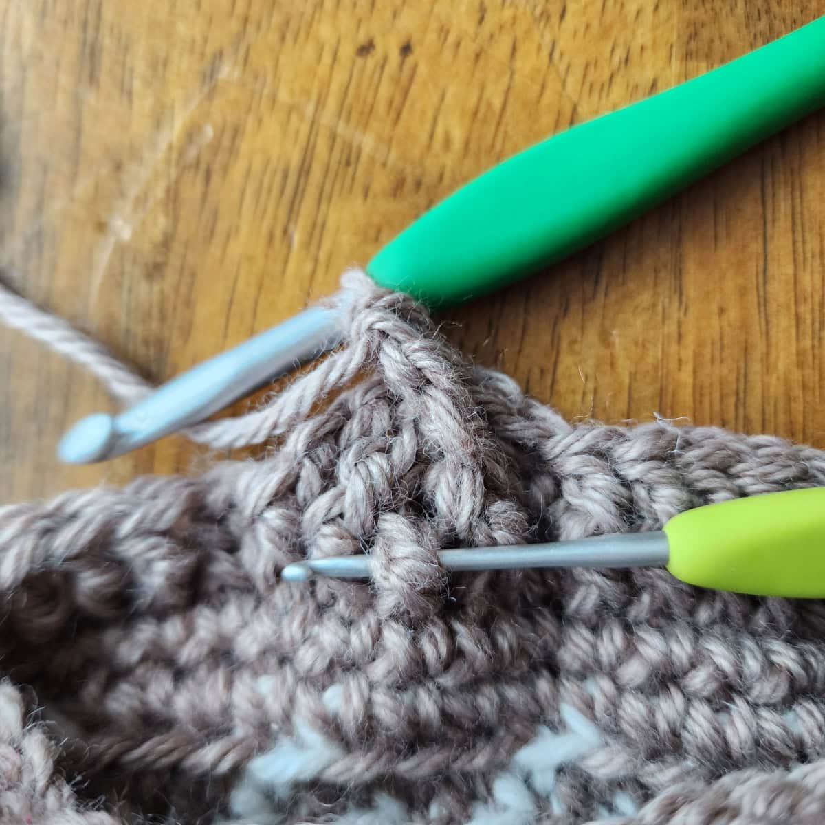 Working the 4-strand cable twists of the decorative cuff of the crochet slipper boot.