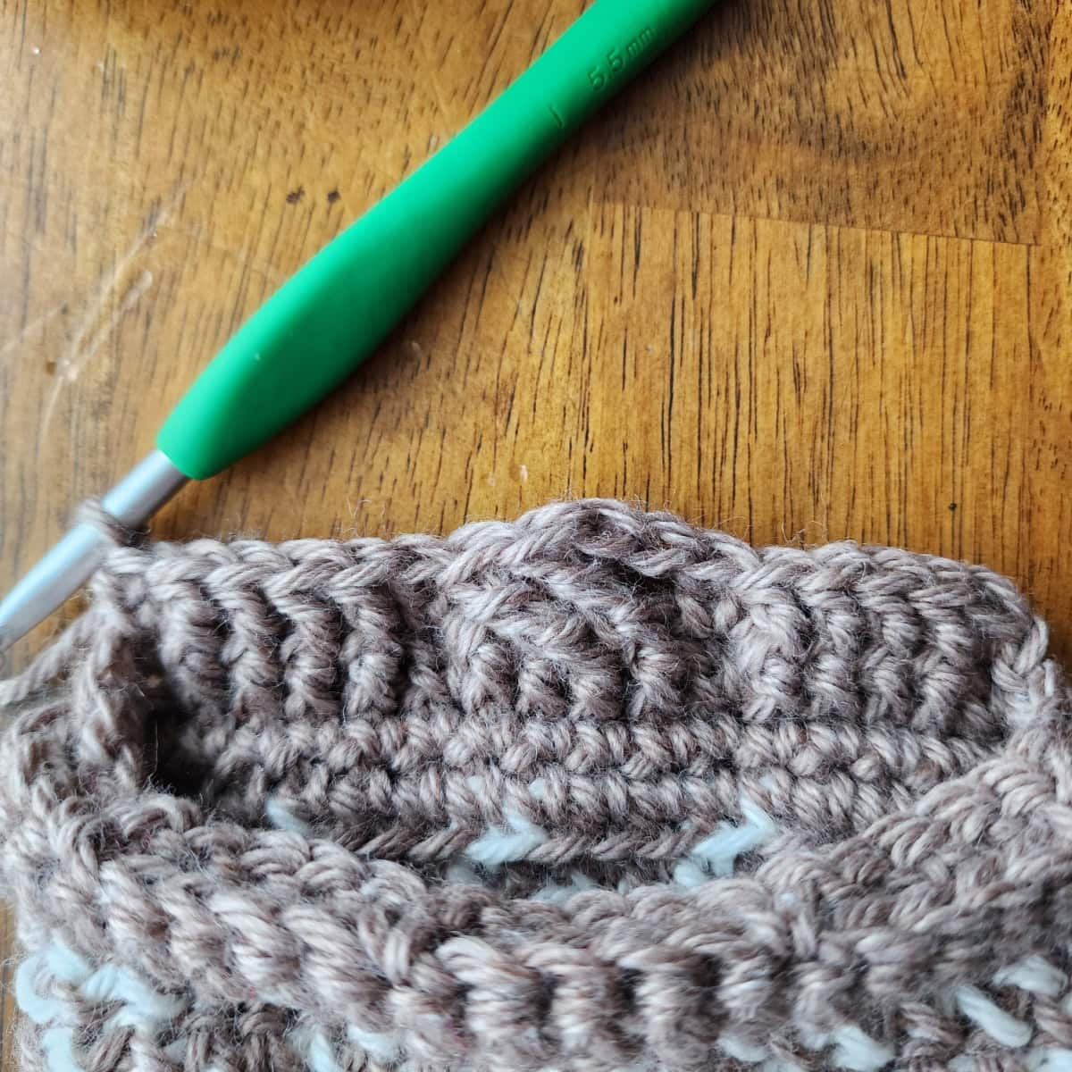 Working the 4-strand cable twists of the decorative cuff of the crochet slipper boot.