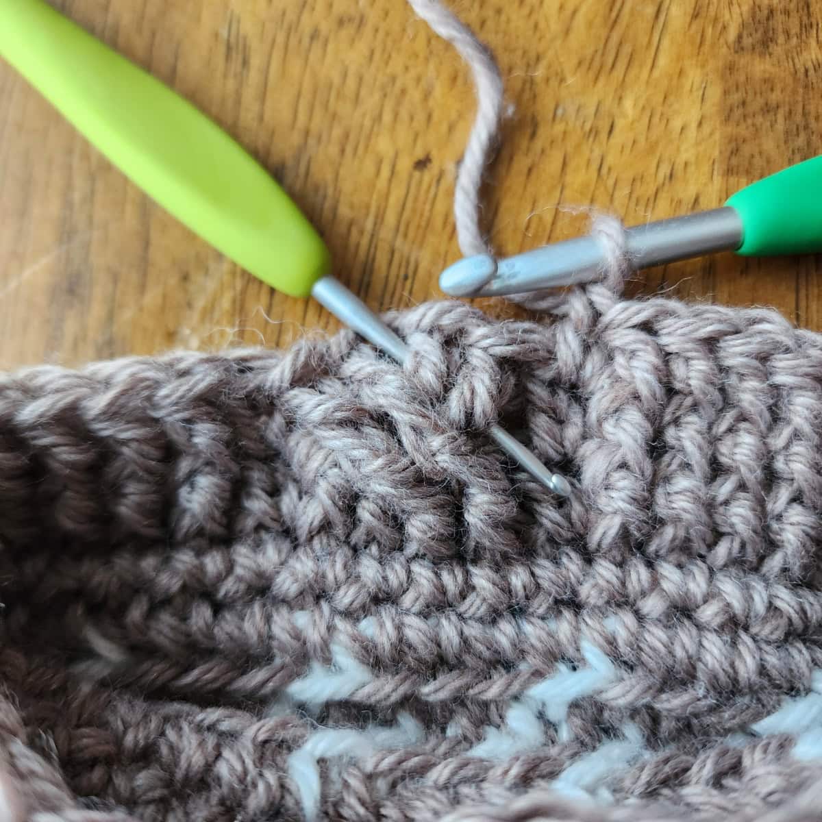 Working the 4-strand cable twists of the decorative cuff of the crochet slipper boot.