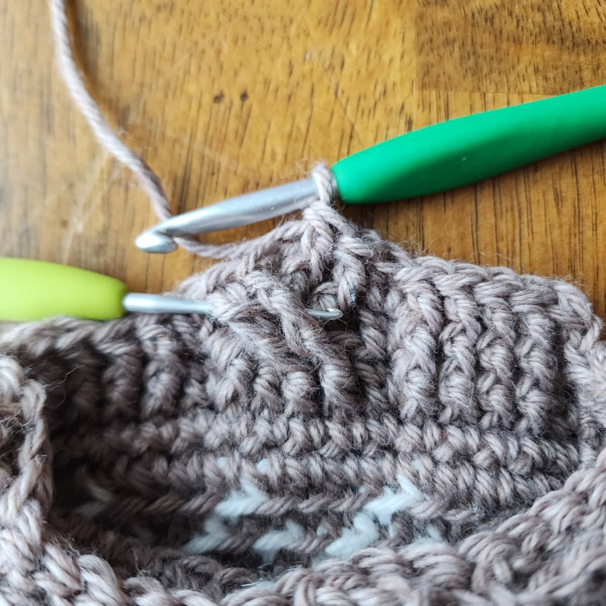 Working the 4-strand cable twists of the decorative cuff of the crochet slipper boot.