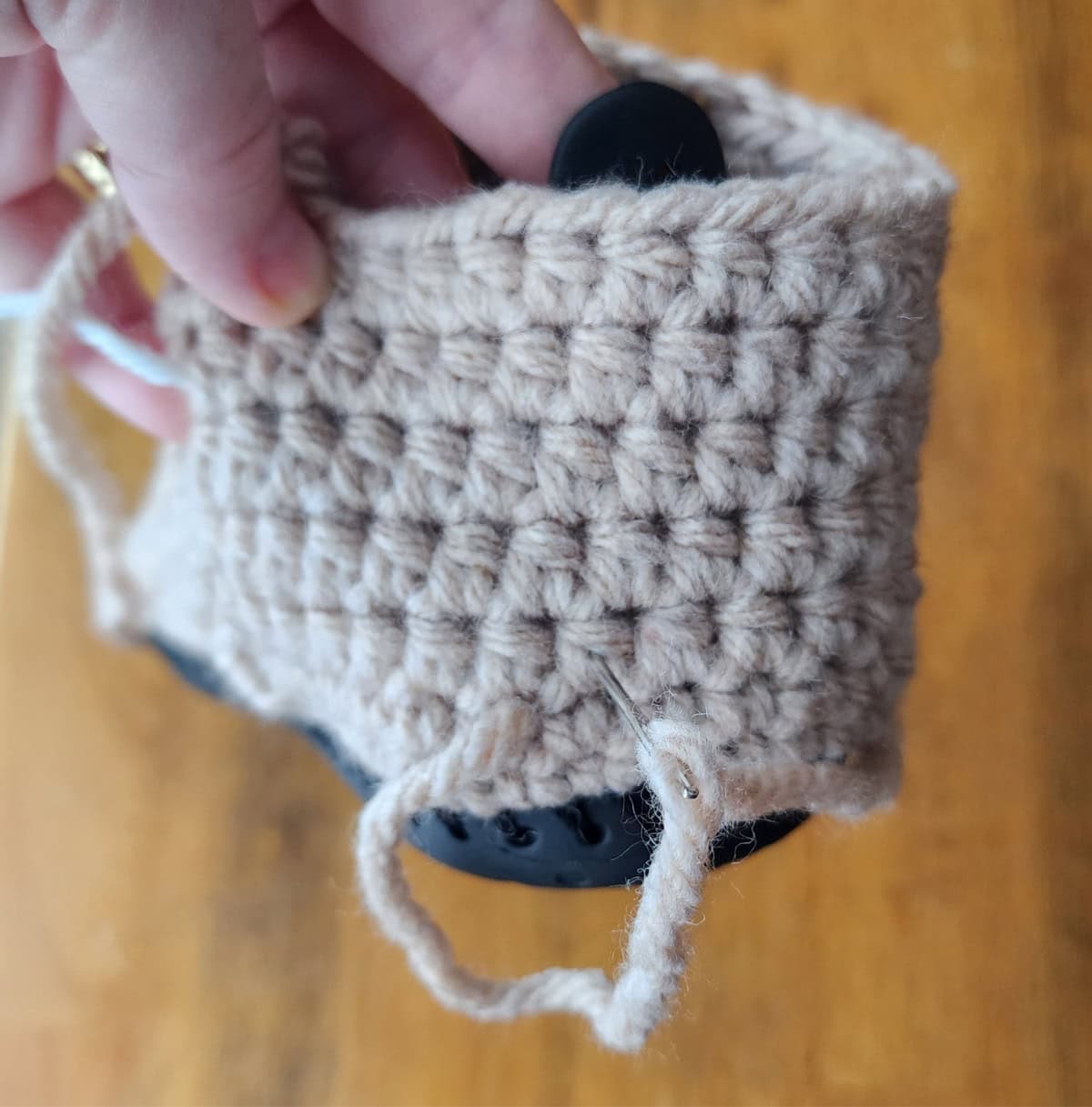 The sole being sewn to the back of the slipper boot