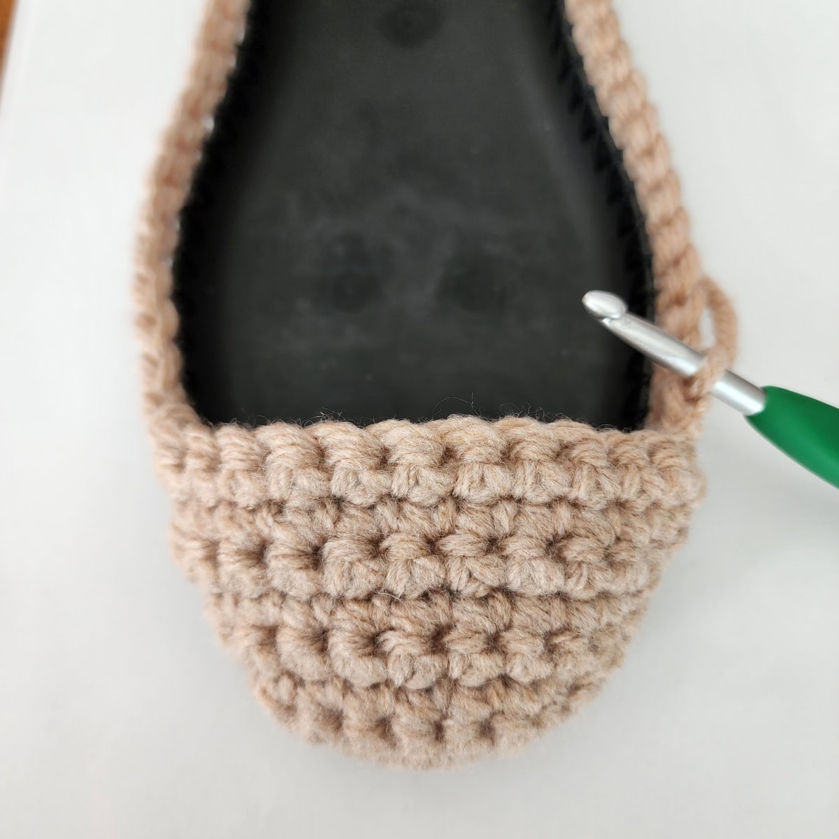 Working the toe and top of foot of the crochet slipper boot.