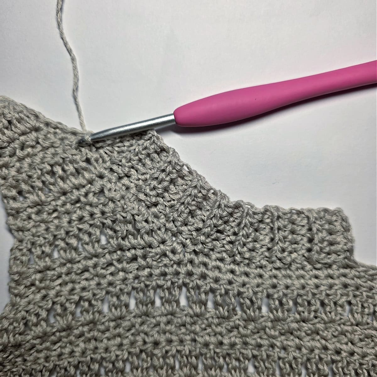 Several completed Rows of the Neck Ribbing of the crochet tank top.