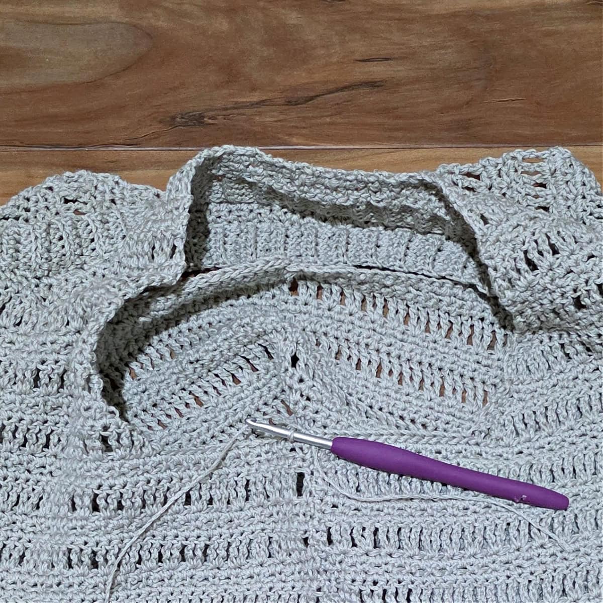 Yarn joined at the bottom of an armhole to begin the Set-Up round before the ribbing of the crochet tank top.