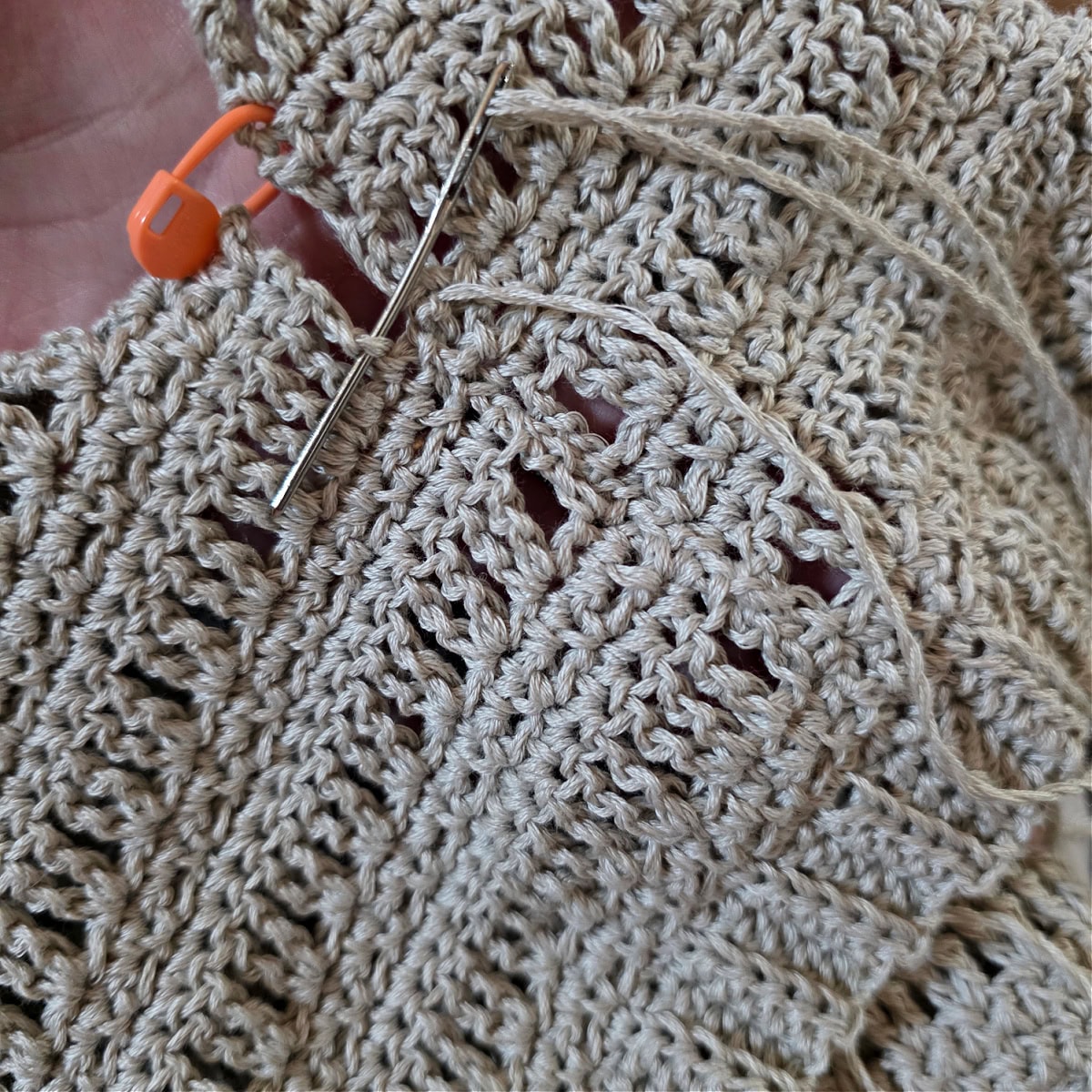 Mattress stitch seam being used to seam one of the sides of the crochet tank top.