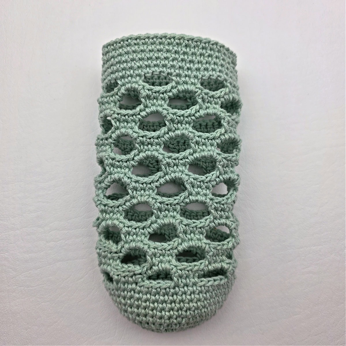 Mint colored crochet water bottle holder without strap.