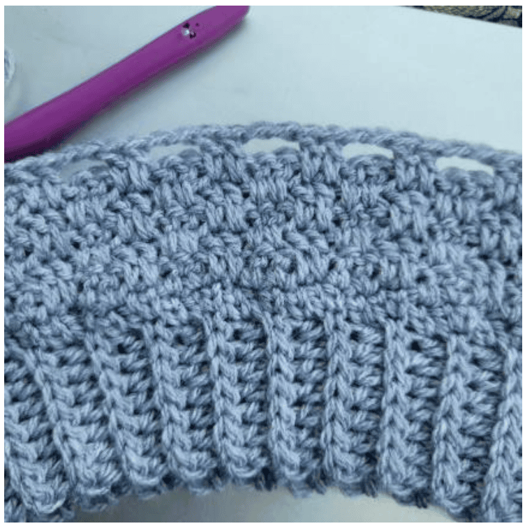 Several rounds of the pattern stitch completed in the body of the crochet vest.