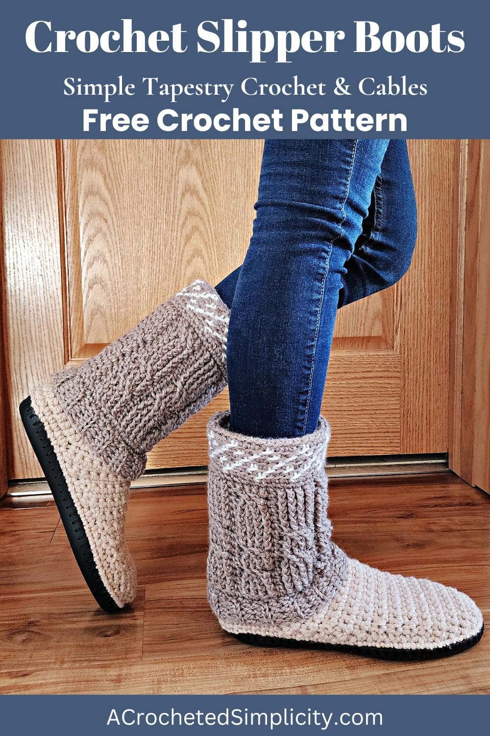 Person wearing blue jeans with a side view of the crochet cable slipper boots on a wooden floor.
