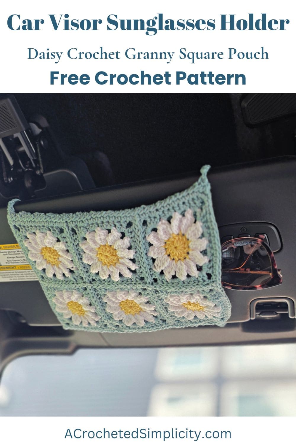 A crochet sunglasses car visor in a car made from six daisy granny squares.