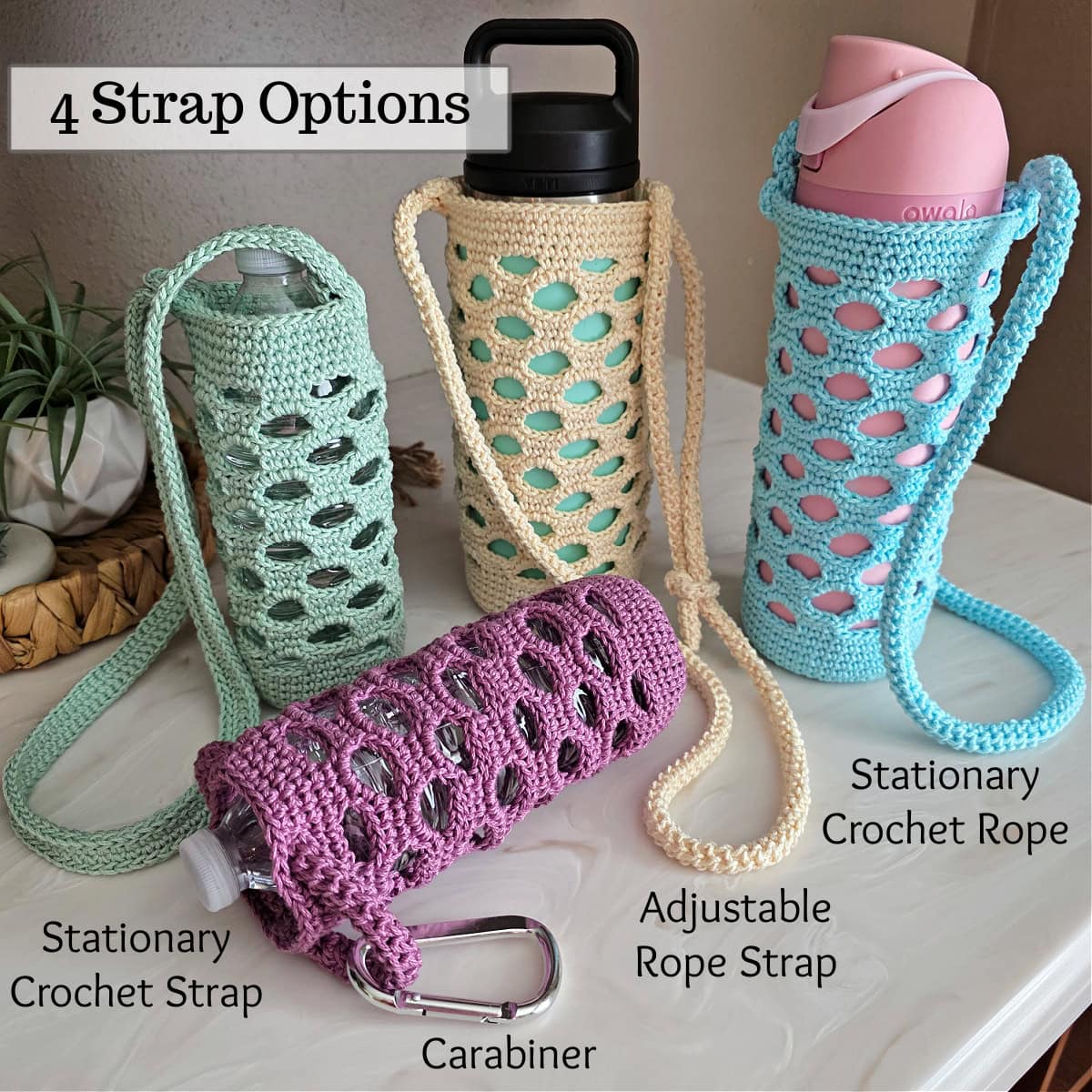 Green, purple, off-white, and blue colored crochet water bottle holders on a white counter.