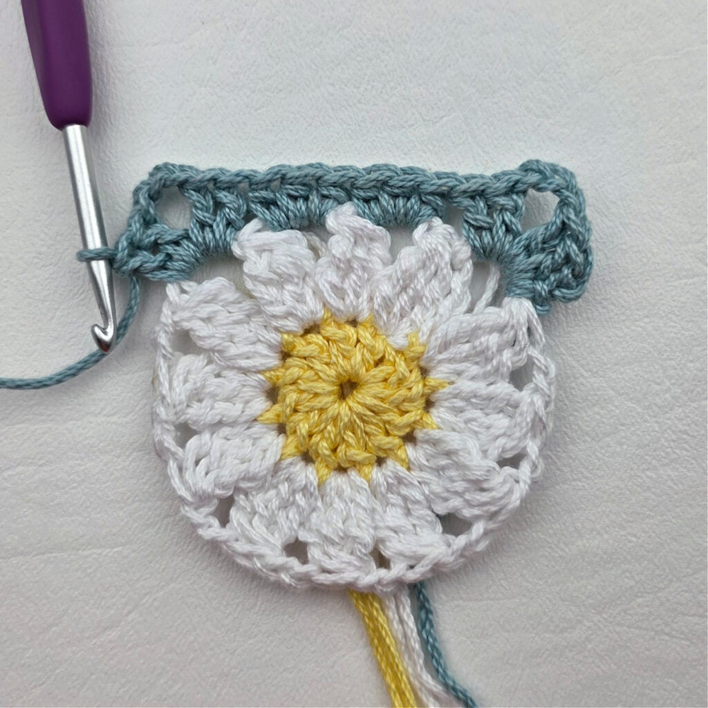 Round 3 of the crochet daisy granny square.
