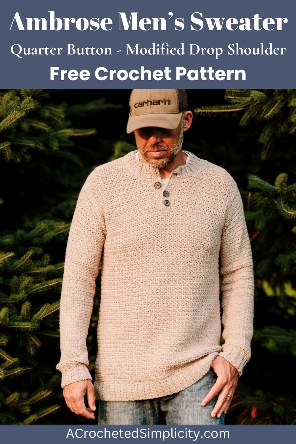 A man standing in a field wearing a beige crochet sweater and hat.