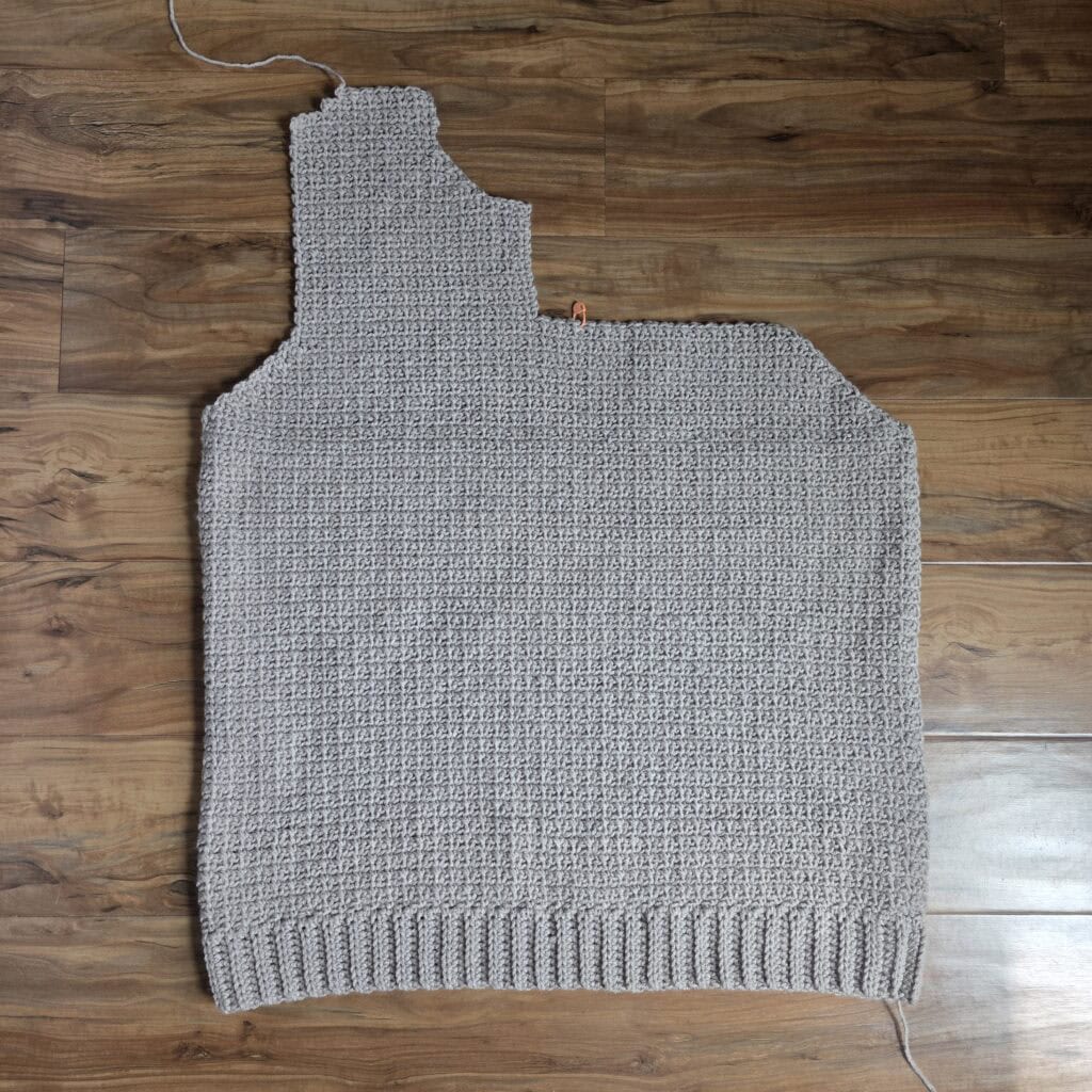 Working the upper right panel of the crochet men's sweater.