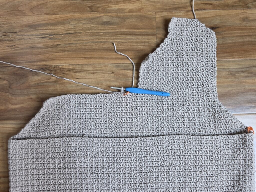 Working the upper left panel of the crochet sweater.