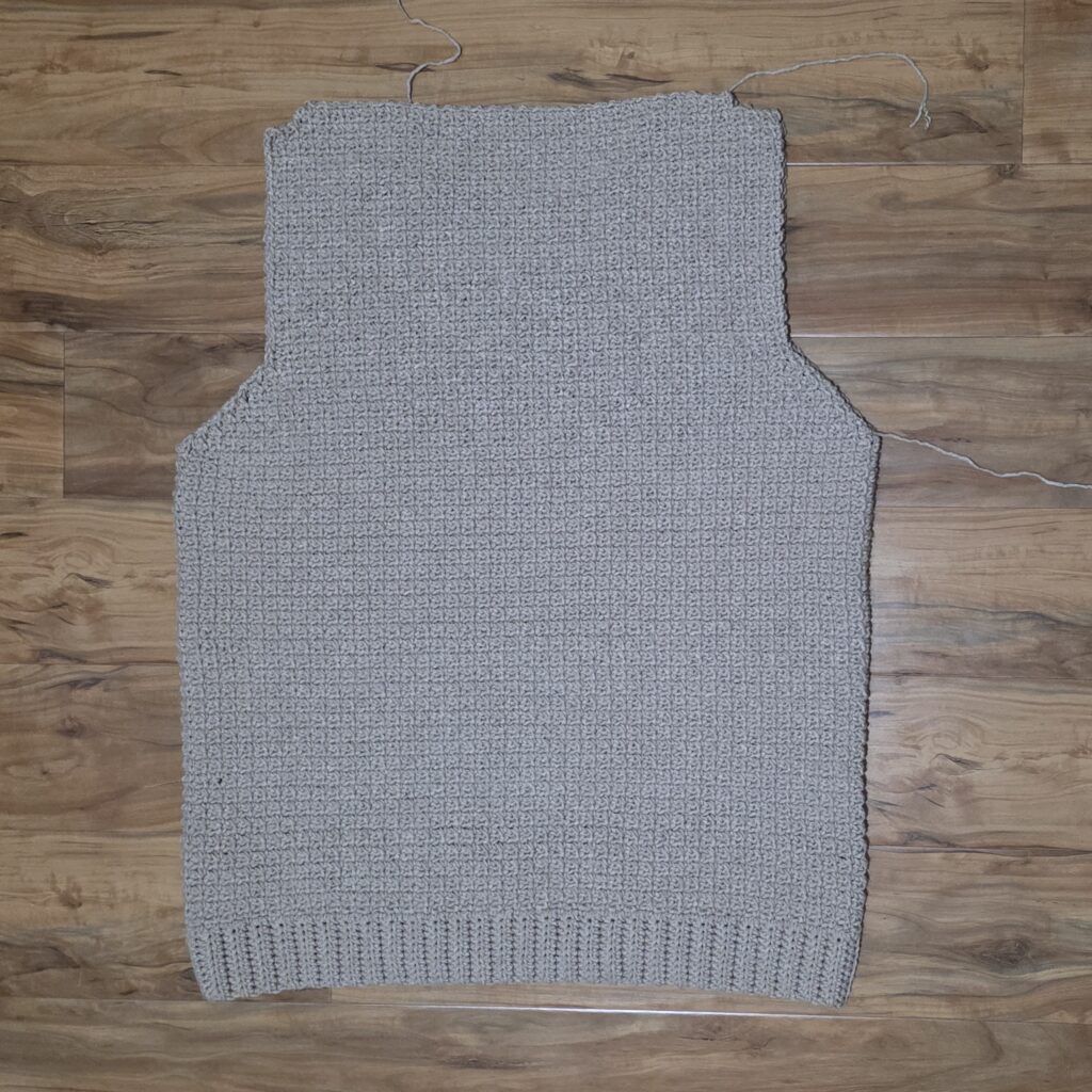 Completed back panel of the crochet sweater.