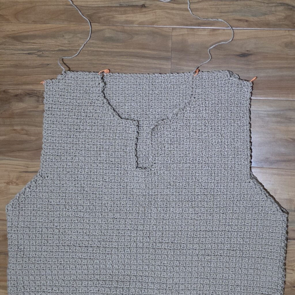 Seaming shoulders of the crochet sweater.