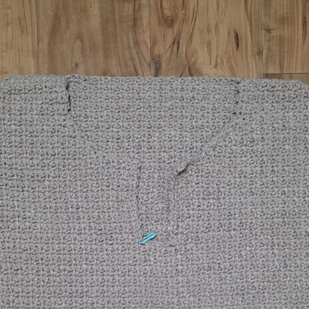 Starting the button flap of the crochet sweater.