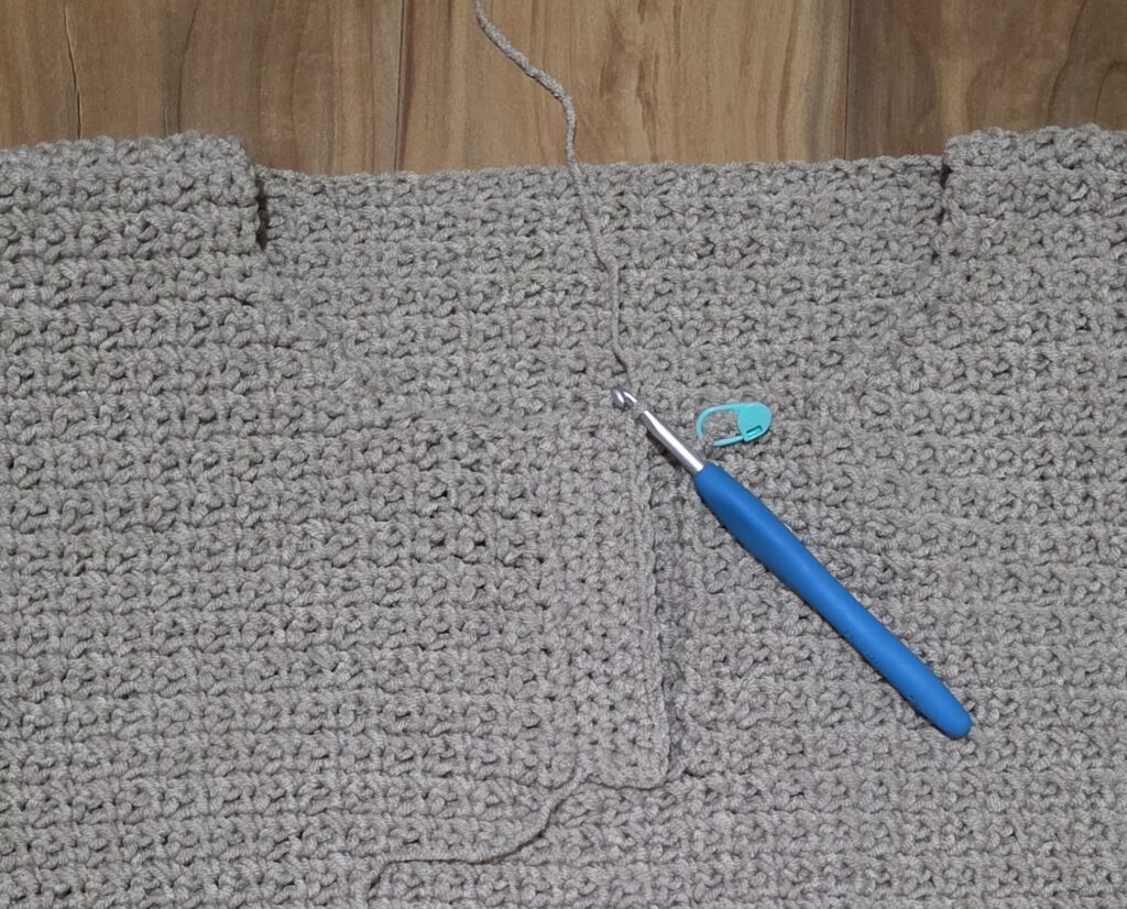Completed button flap of the crochet sweater.