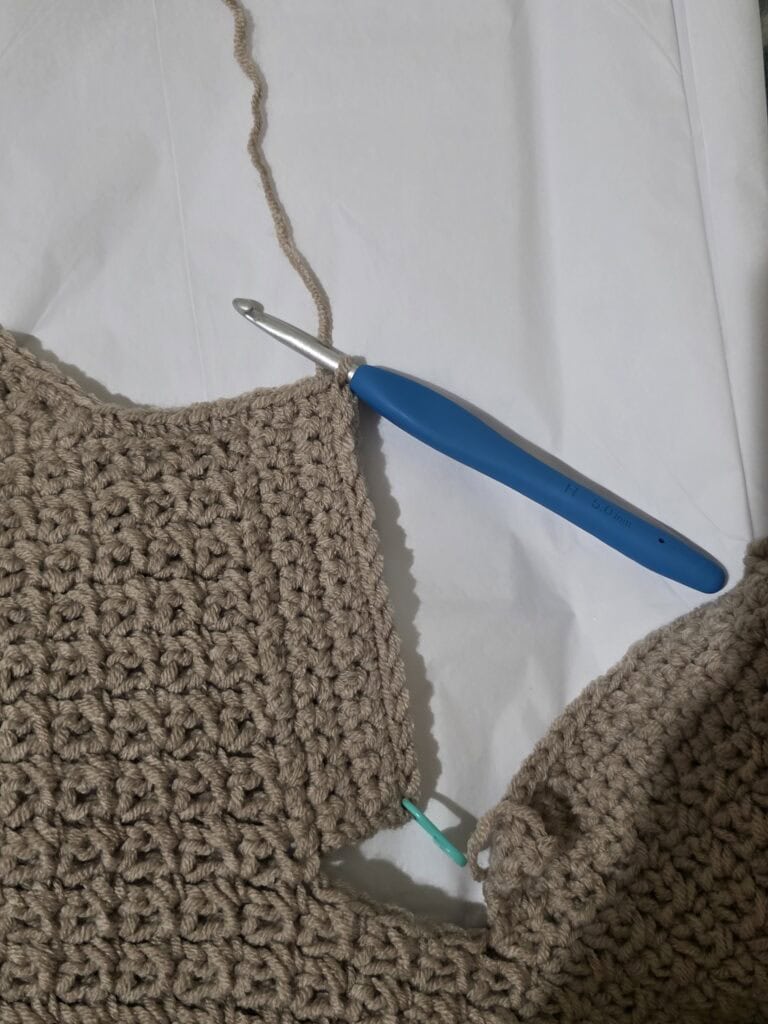 Working the collar ribbing of the crochet sweater.