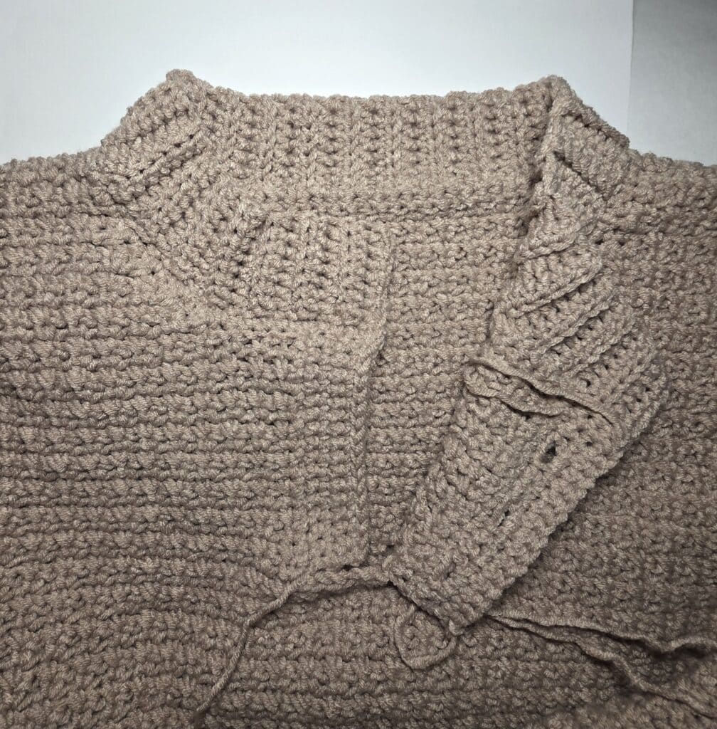 Working the collar ribbing of the crochet sweater.