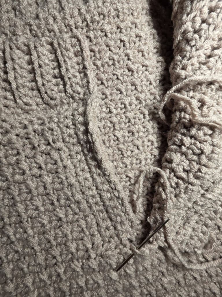 Working the collar ribbing of the crochet sweater.
