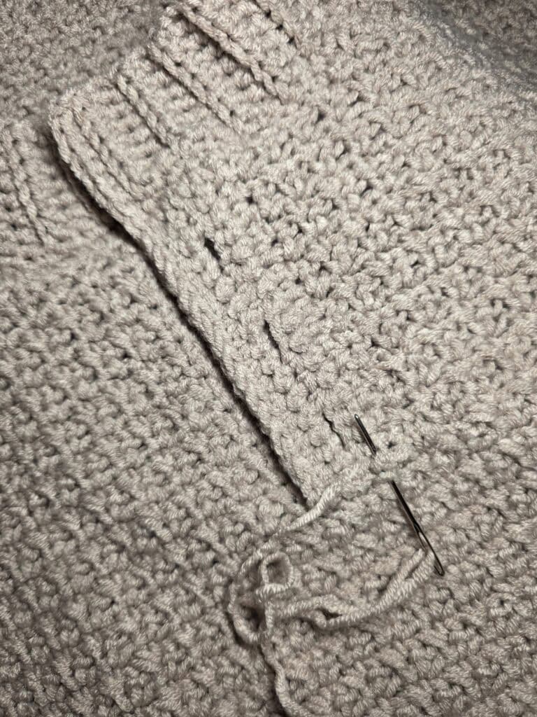 Working the collar ribbing of the crochet sweater.