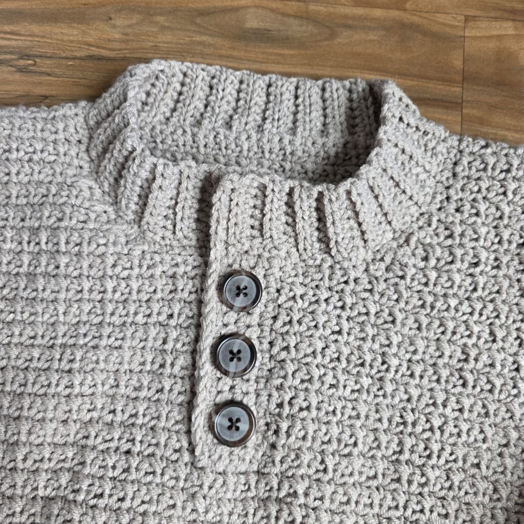 Buttons attached to the crochet sweater.