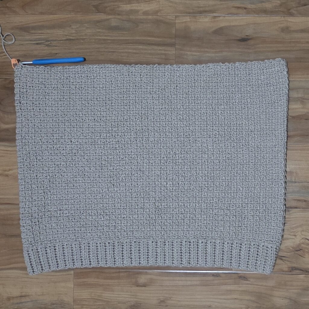 Working the upper front panel of the crochet sweater.