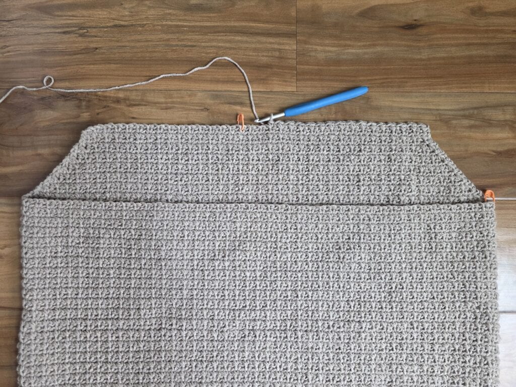 Working the upper right panel of the crochet sweater.