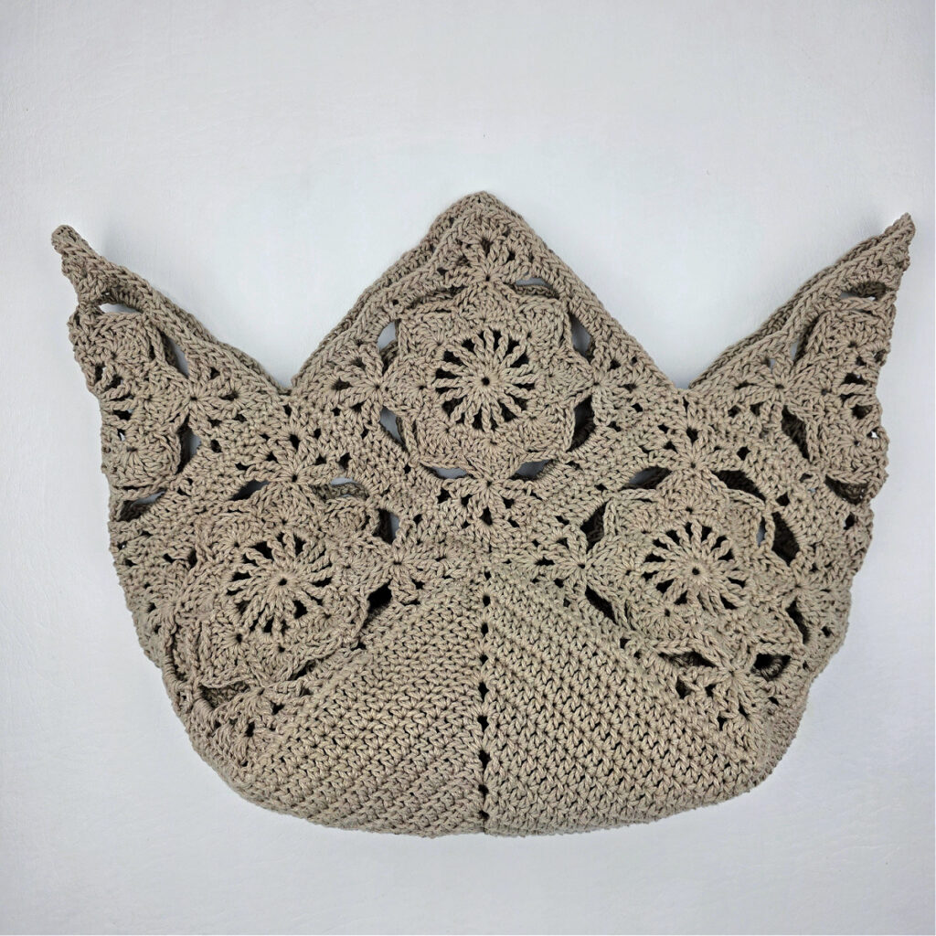 Attaching the bottom to a crochet granny square bag.