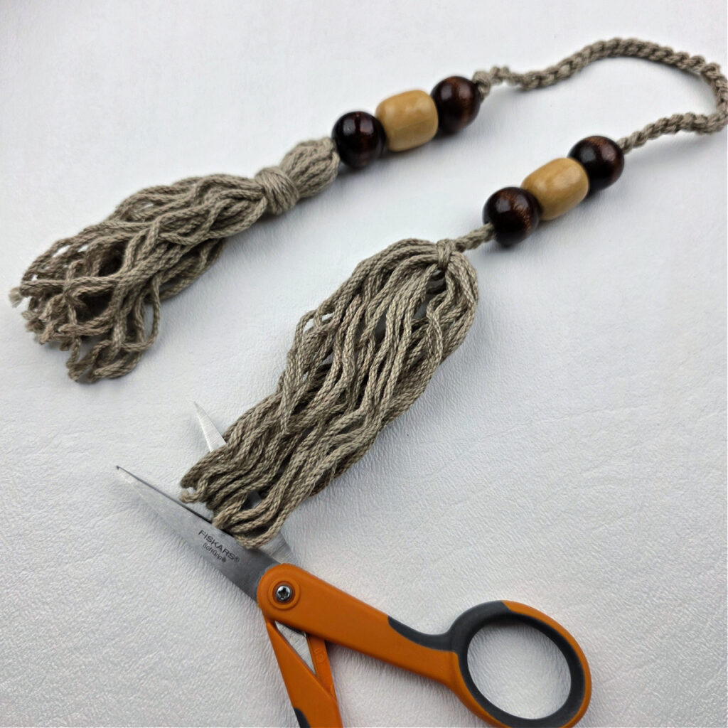 Two handmade yarn tassels with beads.